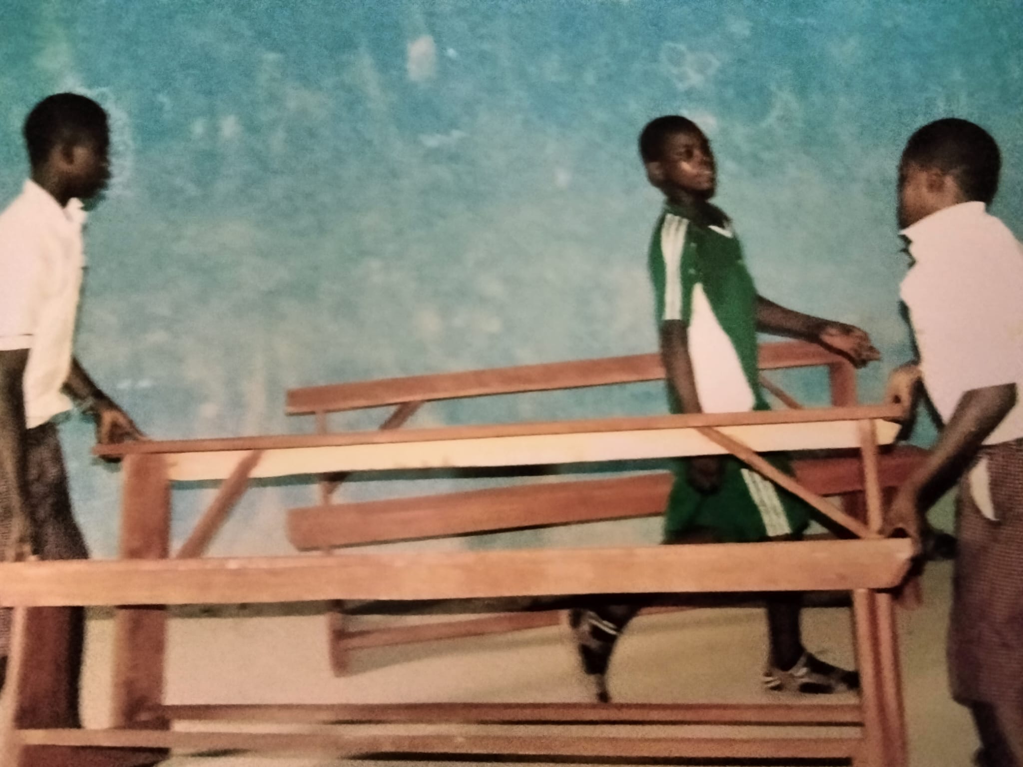 School children carry desks